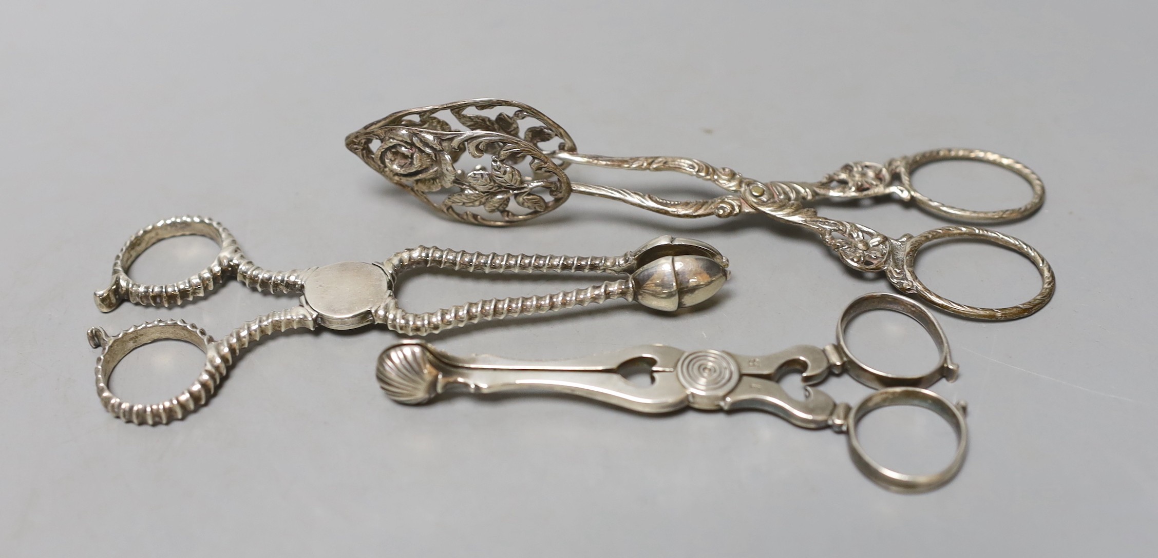 Two pairs of 18th century silver sugar nips, one with makers mark SW and one other later continental white metal pair, largest 14cm